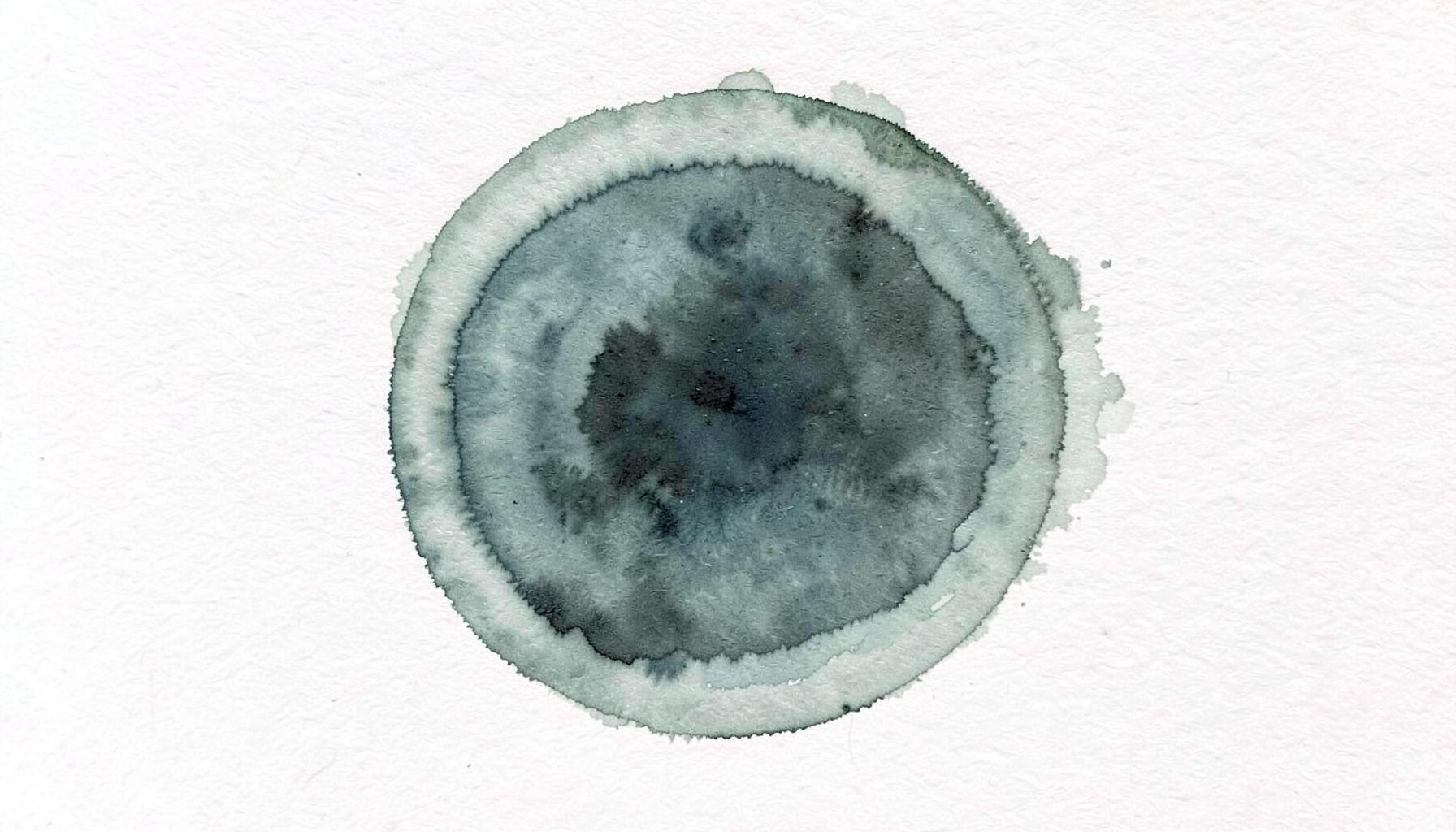 A soft watercolour painting of a simple circular emblem in muted sage green and charcoal, suggesting an organizational badge or seal.